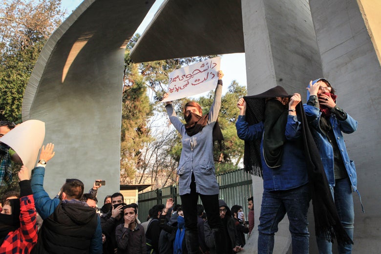 Iranian students protest at the University of Tehran during a demonstration driven by anger over economic problems, in the capital Tehran on December 30, 2017.
        Students protested in a third day of demonstrations sparked by anger over Iran's economic problems, videos on social media showed, but were outnumbered by counter-demonstrators. / AFP PHOTO / STR        (Photo credit should read STR/AFP/Getty Images)